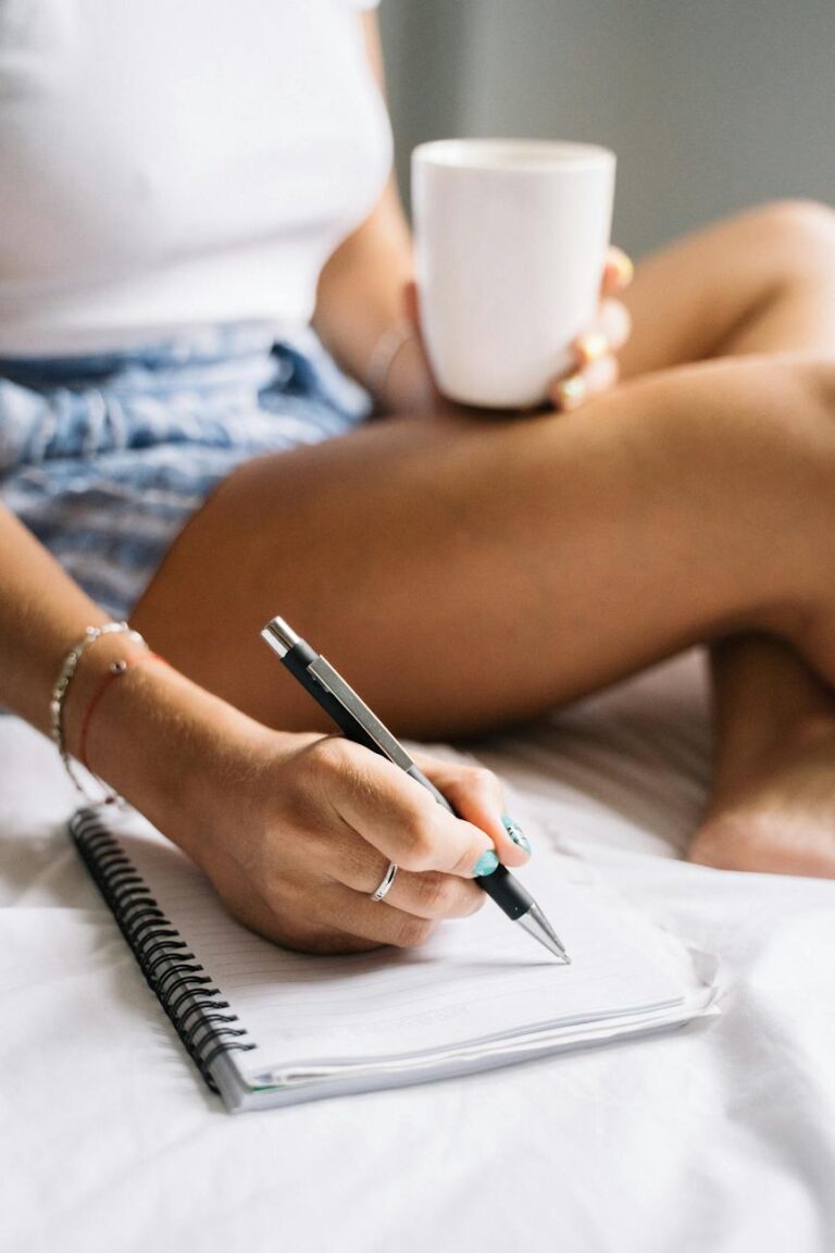 woman drinking coffee and writing a note